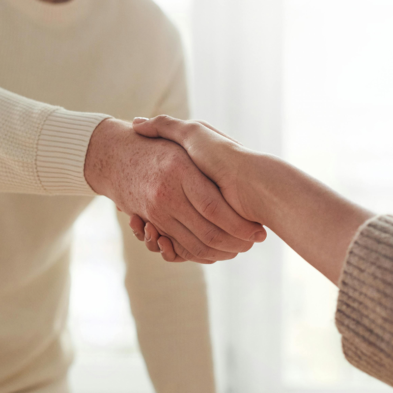 Two people shaking hands, signifying a partnership